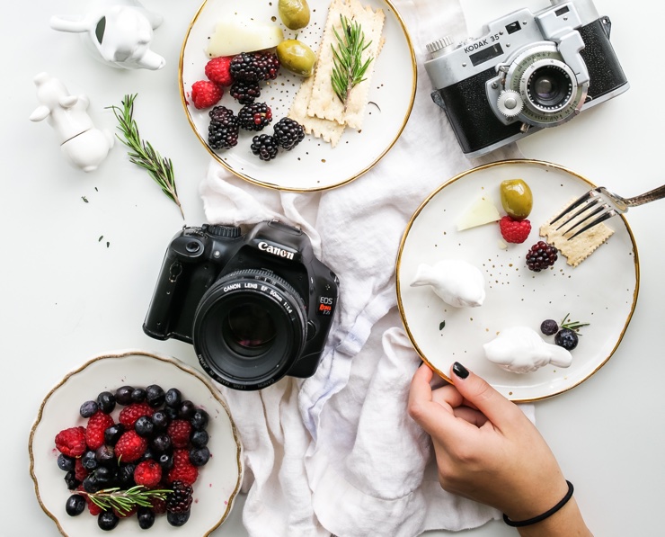 A bright white photography set featuring plates of food