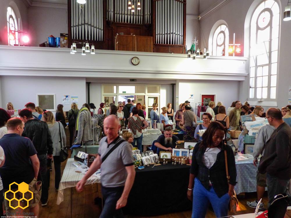A busy craft fair being held in a chapel