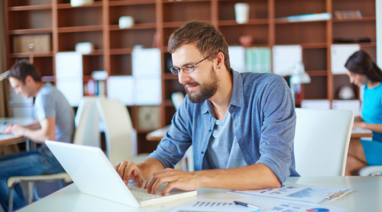 Working at a laptop in a shared workspace