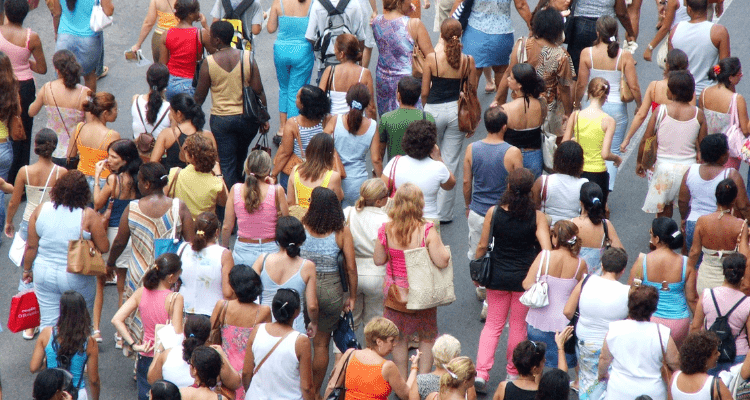 A crowd of people outdoors walking in one direction