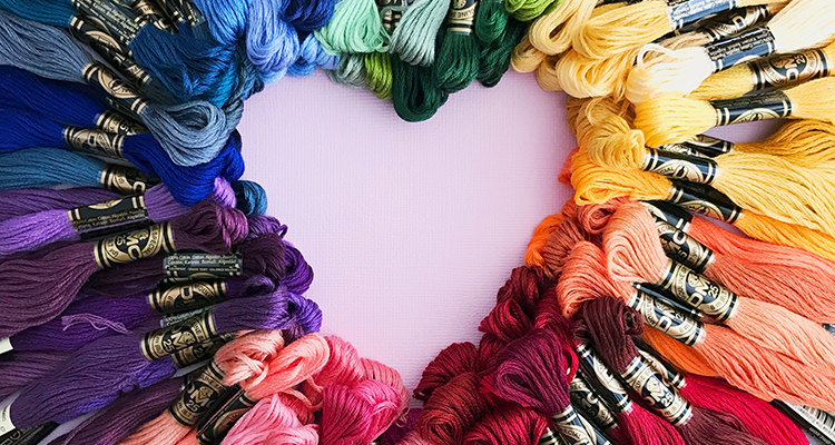 Assortment of different threads arranged to form the shape of a heart