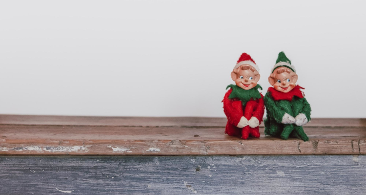 Two elves sitting on a shelf