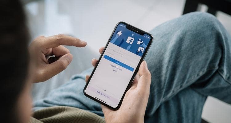 A person signing into Facebook on their phone