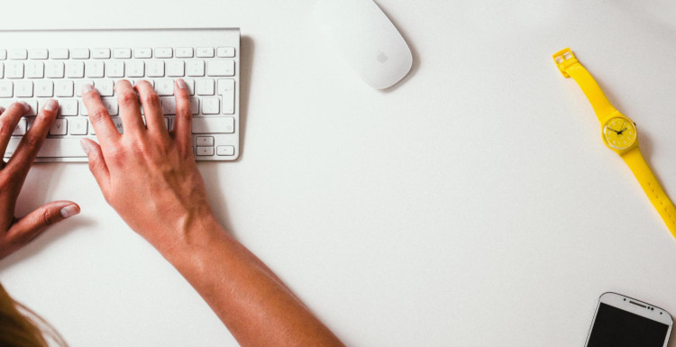 Person working at a computer keyboard