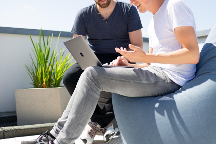 Two people working together at a computer