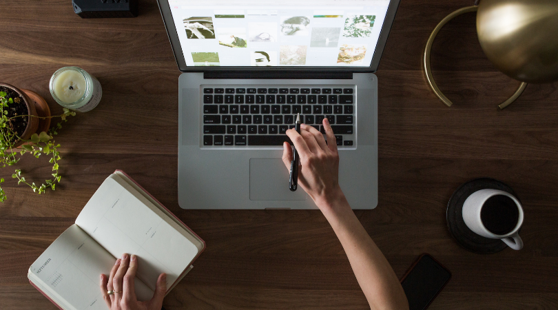 A person researching green practices at their desk