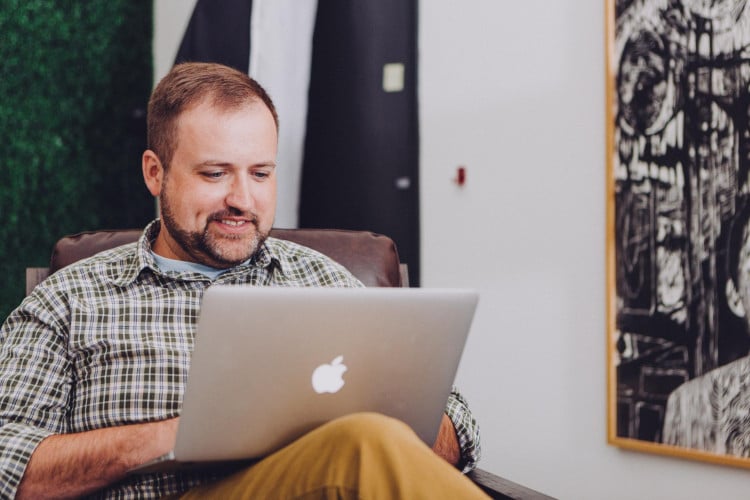 Person enthusiastically working at their laptop