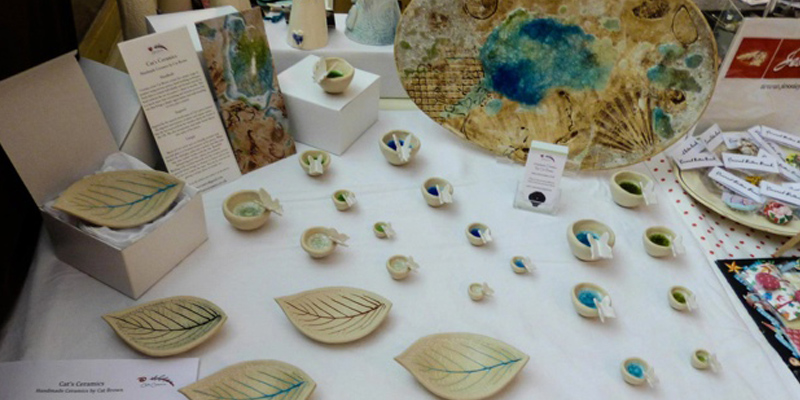 Table of art work for sale at an exhibition 