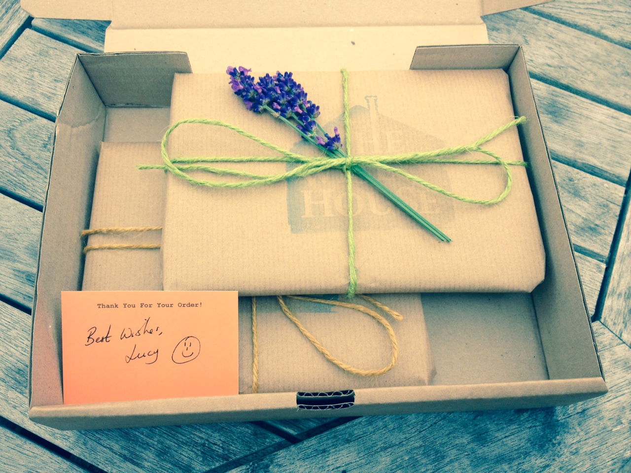 An example of a neatly presented, opened, parcel with a flower and personal note inside